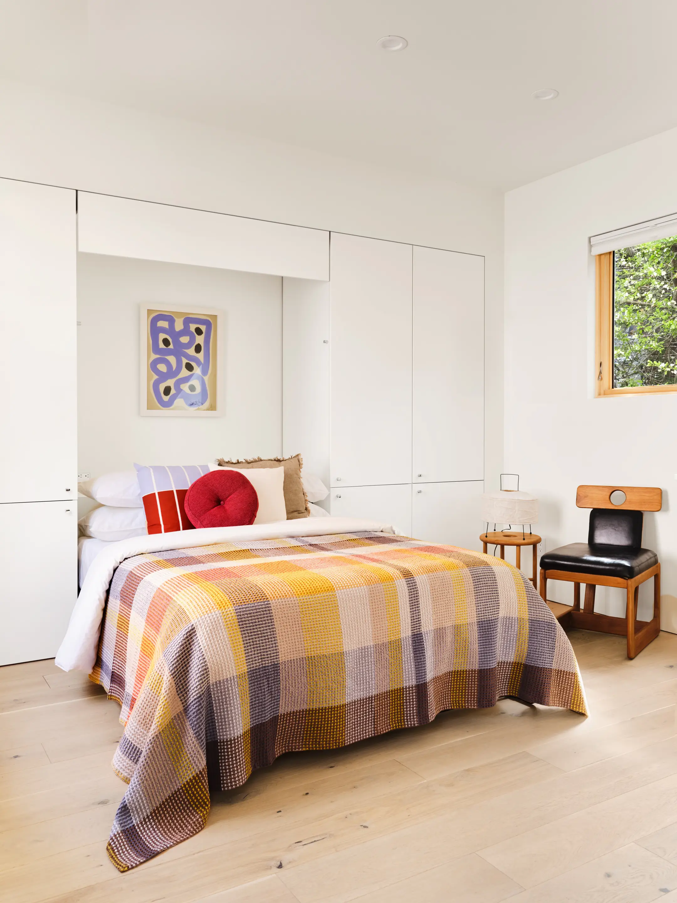 Transformative built-in Murphy bed in Type Five ADU allowing multi-functional space conversion from bedroom to office or living area