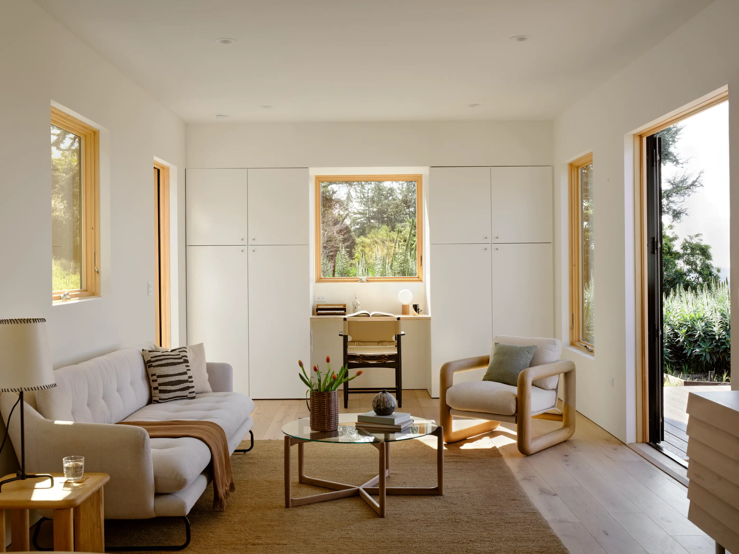 Seamless indoor-outdoor connection in Type Five ADU with large sliding doors and strategically placed windows enhancing natural light